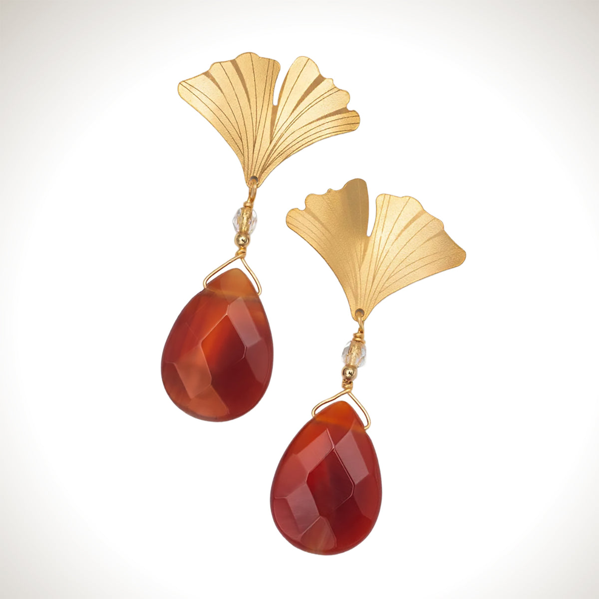 Holly Yashi Gingko Gem Drop earrings with gold-plated fan-shaped leaves, delicate vein detailing, and faceted red aventurine teardrop pendants.