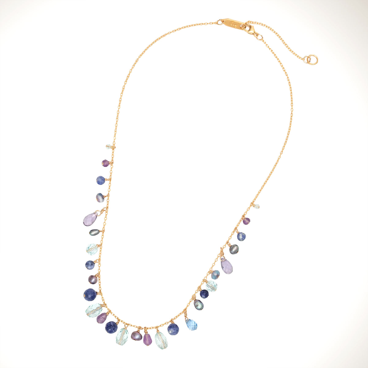 A gold chain necklace featuring a graduated dangle design with teardrop-shaped gemstones in shades of blue, purple, and clear, displayed on a clean white background.